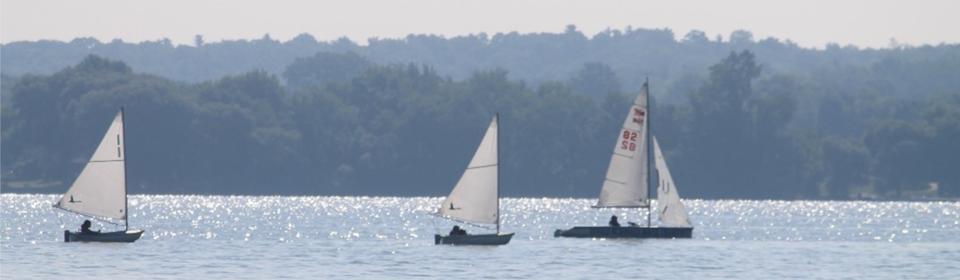Three sailboats on the Bay of Quinte.